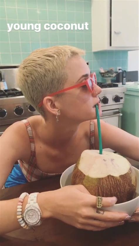 A Woman In Glasses Drinking From A Coconut Drink