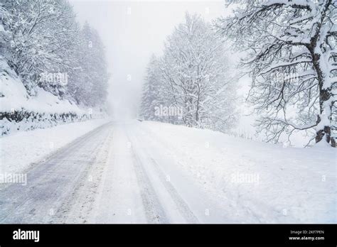 Poor Visibility Along A Snow Covered Mountain Road During A Winter