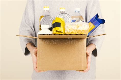 Woman Hands Holding Cardbox With Grocery Products Volunteer Collecting