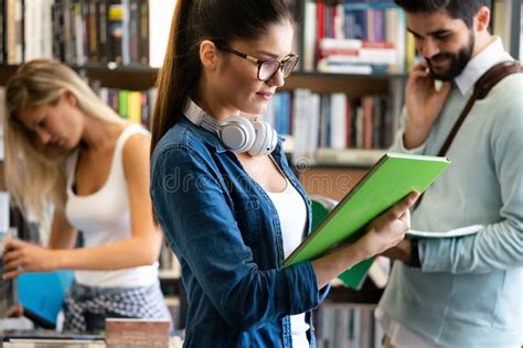 Group Of Happy College Students Studying At Campus Library Together