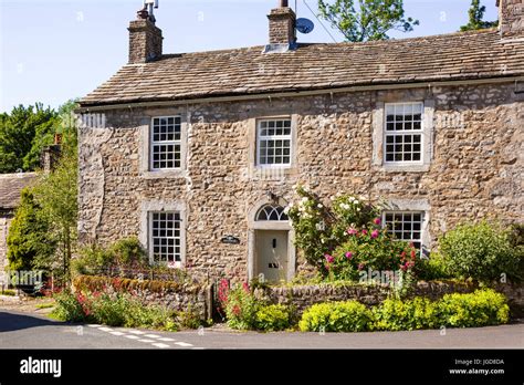 A Typical Solid Yorkshire Dales Stone Farmhouse In The Village Of