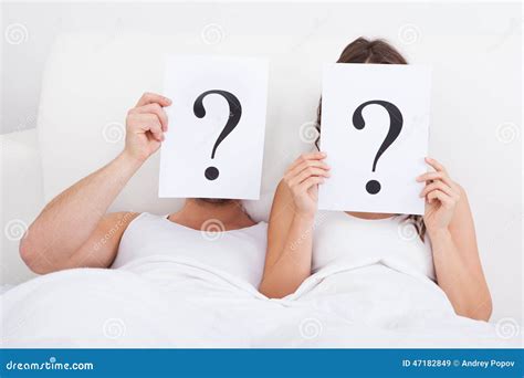 Couple Lying On Bed Holding Question Mark Stock Image Image Of Finger Question 47182849