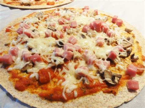 A Pizza With Ham Mushrooms And Cheese On It