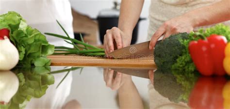 Closeup Of Human Hands Cooking In Kitchen Mother And Daughter Or Two