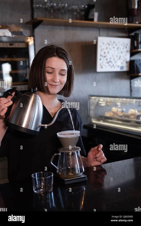 Charming Brunette Woman Barista Making Filter Coffee In Coffee Shop