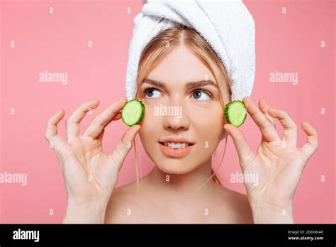 Attractive Cheerful Woman With A Towel Wrapped Around Her Head Holding