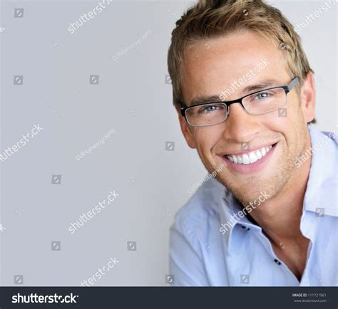 Young Handsome Man With Great Smile Wearing Fashion Eyeglasses Against Neutral Background With