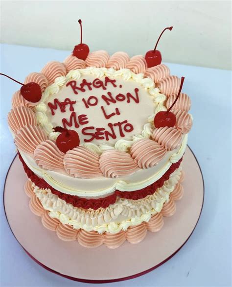 A Birthday Cake With Cherries And Writing On The Top Is Sitting On A Plate