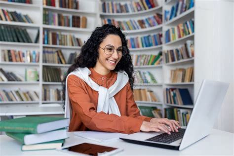 Smiling Casual Brunette Typing On Laptop Keyboard While Sitting In
