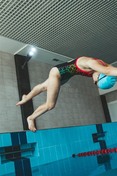 The Girl is Engaged in Synchronized Swimming in the Pool. Pool Jump Trick. the Swimmer Jumps ...