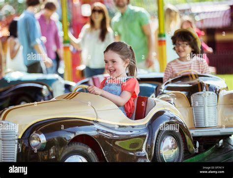 Cheerful Girl On Carousel In Amusement Park Stock Photo Alamy