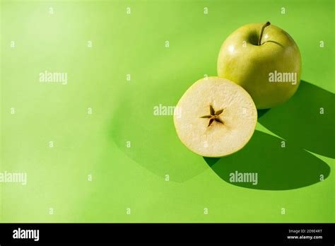 Green Apple Whole And Cut Half On A Green Background Star Shaped Apple