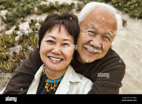 Happy Mature Couple Hugging On Beach Stock Photo Alamy