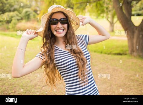 Pretty Brunette Wearing Straw Hat And Looking At Camera Stock Photo Alamy
