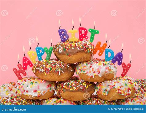 Donuts Stacked With Happy Birthday Candles Pink Background Stock Photo
