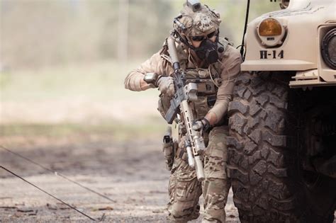 Premium Photo Soldiers In Camouflage Uniforms Hold Weapons Ready To