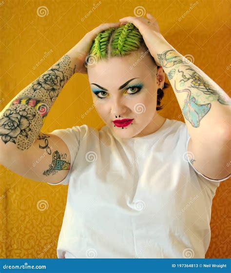 Punk Girl With Attitude Green Hair Tattoos Facial Piercings Stock