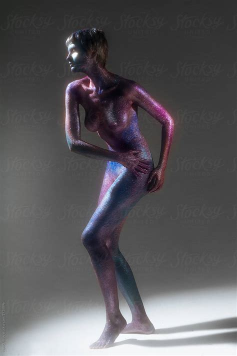 Nude Woman With Space Bodypainting Poses In A Dance Pose On A White Cyclorama By Stocksy