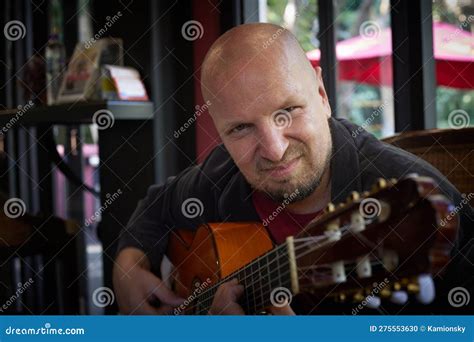 Handsome Guy Showcases Musical Talent With Acoustic Guitar At Show