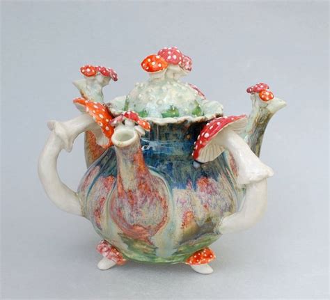 A Ceramic Tea Pot With Mushrooms On It