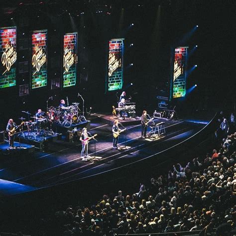 a group of people standing on top of a stage in front of a large crowd