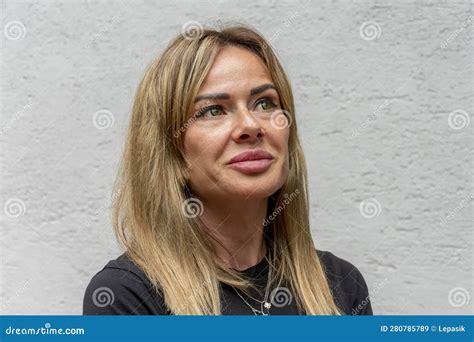 Emotional Portrait Of A Middle Aged Blonde Woman On A Light Background