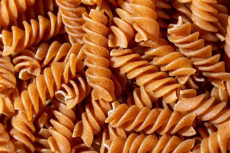 Premium Photo Uncooked Whole Grain Fusilli Pasta Background