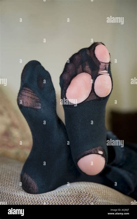 Worn Socks With Feet And Toes Showing Through The Holes Stock Photo