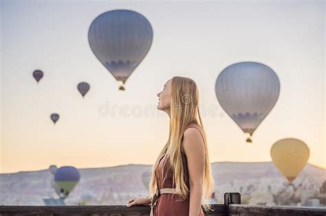 Tourist Woman Looking At Hot Air Balloons In Cappadocia Turkey Happy Travel In Turkey Concept