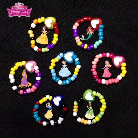 Six Disney Princess Bracelets With Beads And Charms On A Black