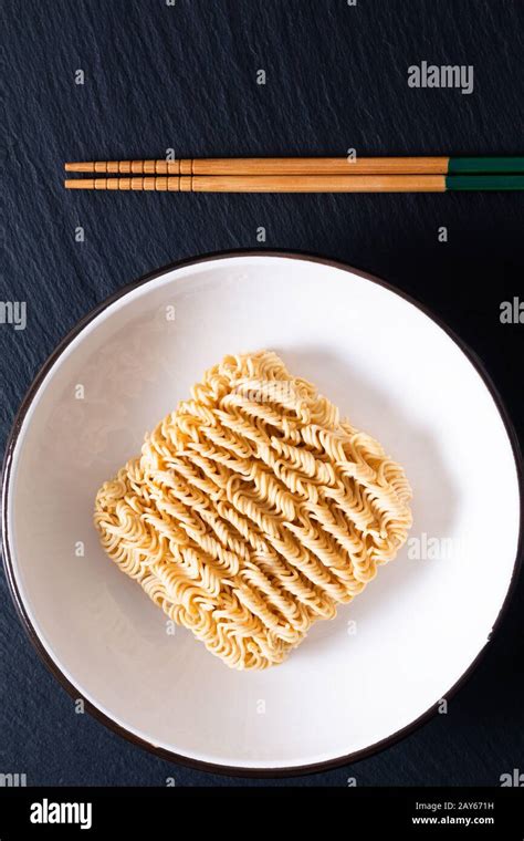 Unhealthy Food Concept Dried Instant Noodles On Black Slate Board