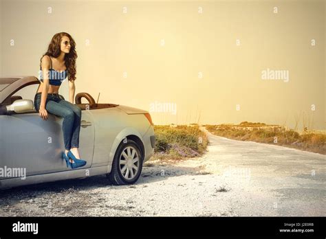 Brunette Woman Sitting On Car Stock Photo Alamy
