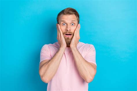 Photo Of Funny Impressed Young Man Wear Pink T Shirt Arms Cheeks Big