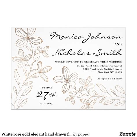 A Wedding Card With Flowers And Leaves In Gold Foil On The Front White