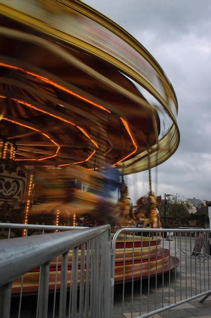 Premium Photo Illuminated Chain Swing Ride Against Cloudy Sky At Sunset