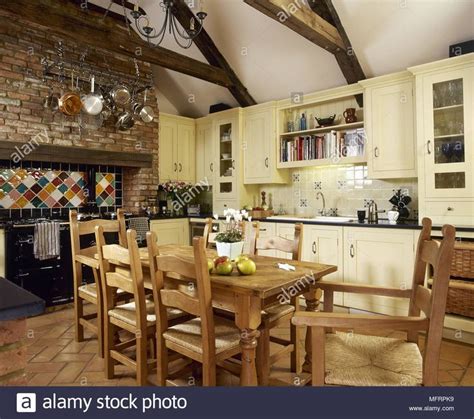 Country Style Kitchen With Pine Dining Table And Chairs Stock Photo