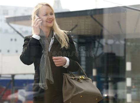 Beautiful Mature Woman Talking On Mobile Phone Outdoors Stock Photo
