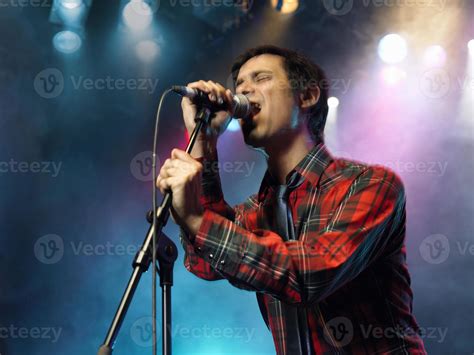 Young Man Singing Into Microphone 1149042 Stock Photo At Vecteezy