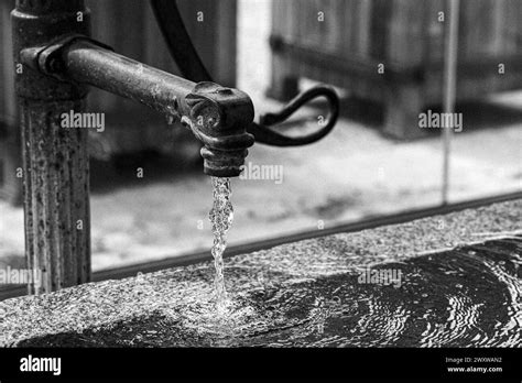 A Close Up Of Water Flowing From A Vintage Garden Faucet Or Tap Stock