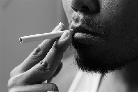 Premium Photo Close Up Of Man Smoking Cigarette