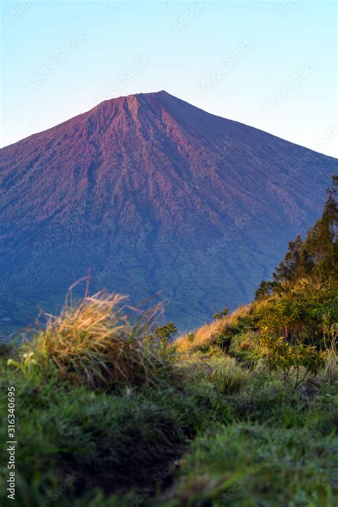 (Selective focus) Stunning view of the Mount Rinjani illuminated by a ...