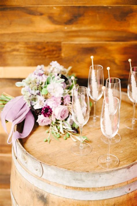 Wine Glasses Are Sitting On Top Of A Barrel