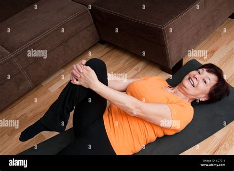 Senior Woman Exercising At Home Stock Photo Alamy