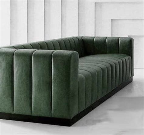 A Green Couch Sitting On Top Of A White Floor