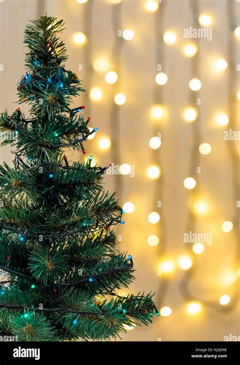 Gold Christmas Background Of De Focused Lights Garland With Decorated