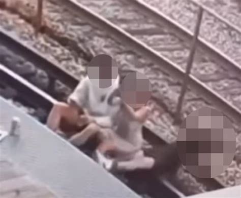 Horrifying moment two people are shocked after accidentally touching electric third rail while ...