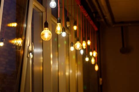 Premium Photo Light Bulbs Of Different Shapes Burn On The Wall