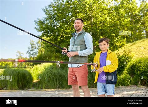 Happy Smiling Father And Son Fishing On River Stock Photo Alamy