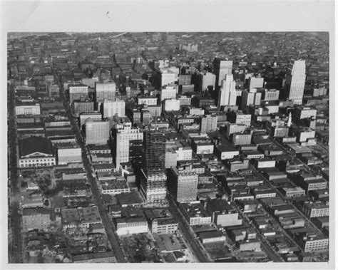 an aerial view of the city with tall buildings