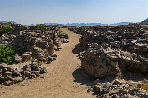 Empty Dirt Road Amidst Rocks At Al Ukhdud Archaeological Site In Najran